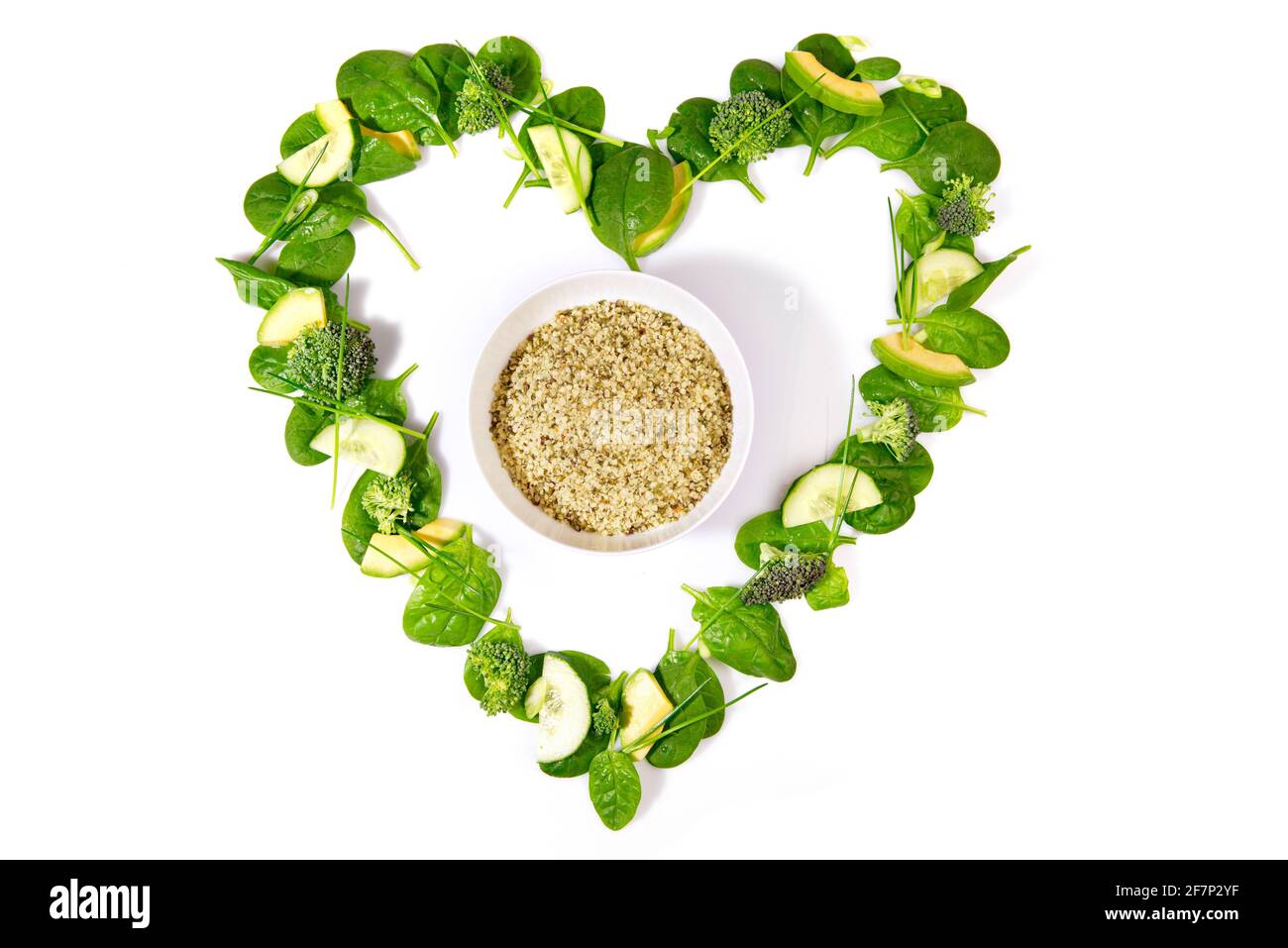 Heart Shape green Detox Salad and Vegetables with Hemp Seeds isolated on white Background Stock Photo