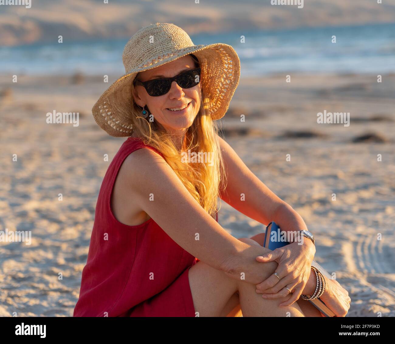 Mature woman enjoying herself on the beach Stock Photo - Alamy