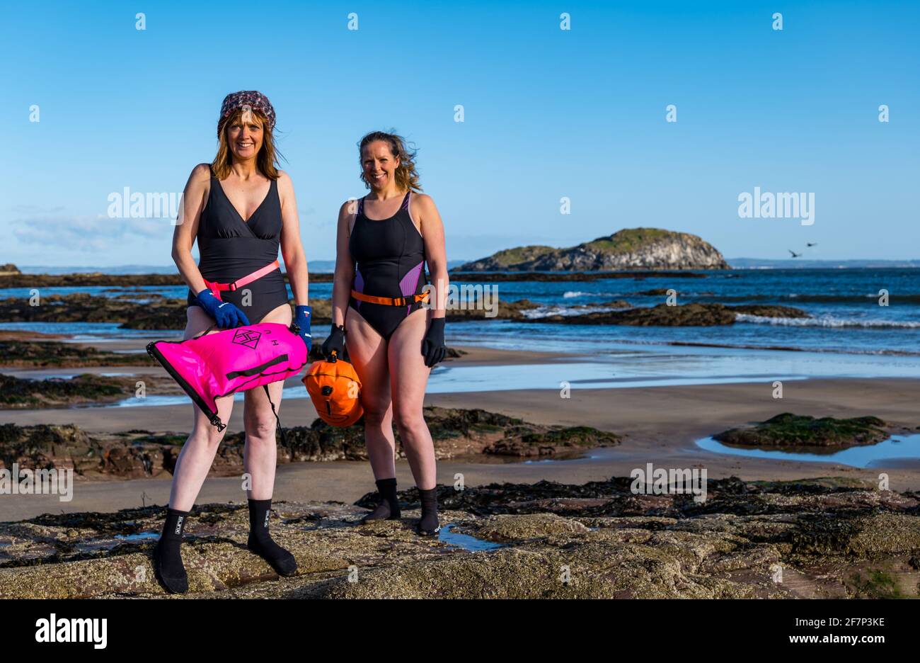 North Berwick, East Lothian, Scotland, United Kingdom, 9th April 2021. Wild swimming fund raising challenge: open water swimmer Rebecca Rennie is undertaking a 24 day challenge, swimming each day until April 24th, to raise money for Edinburgh Women’s Aid via the virtual Kilt Walk. She is joined by various friends each day. North Berwick was recently deemed the best place to live in Scotland; bays for swimming are one of its attractions Stock Photo