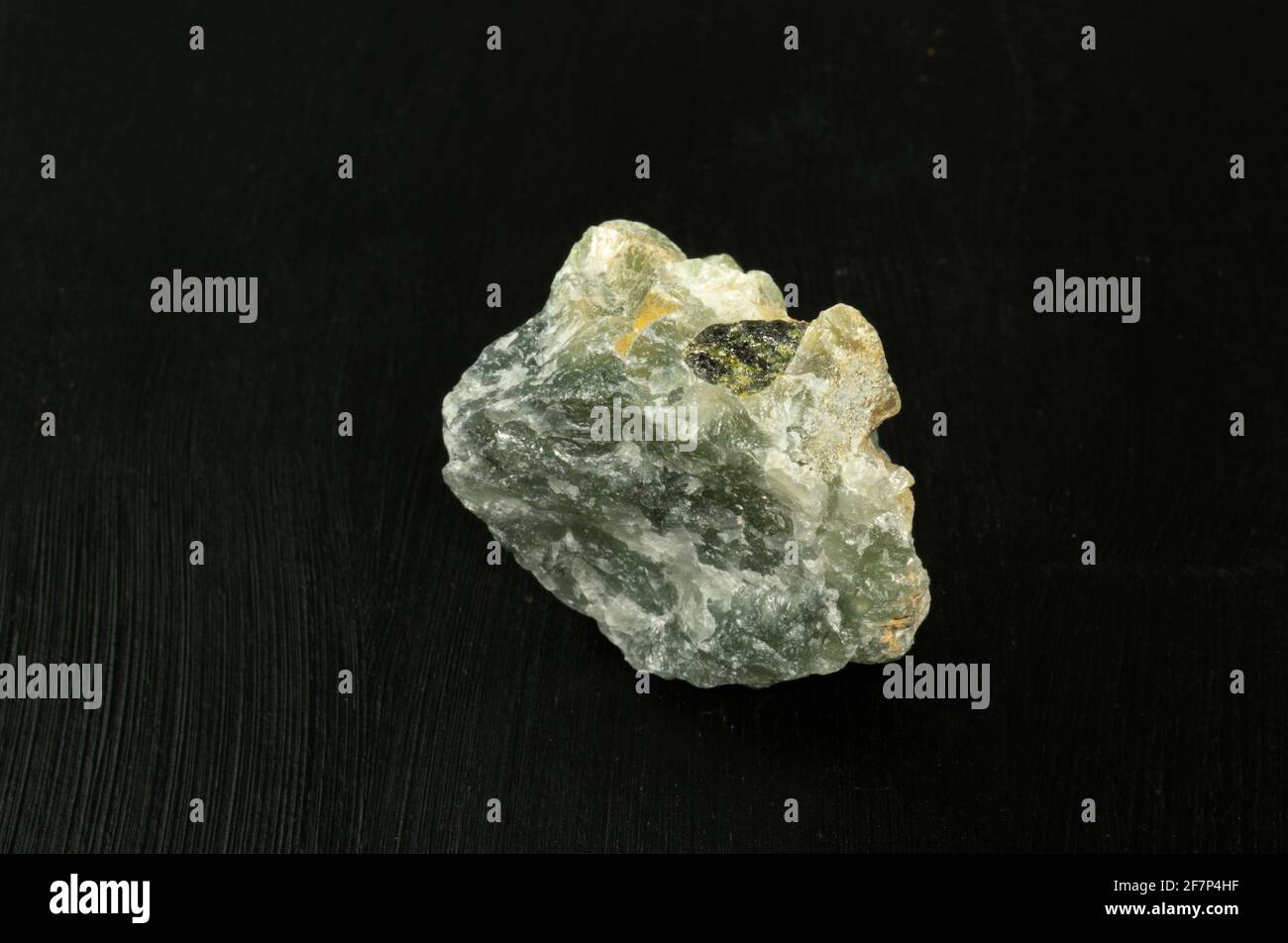 Prehnite green natural mineral stone from Republic of South Africa RSA on black background. Mineralogy, geology, magic of stones, semi-precious stones Stock Photo