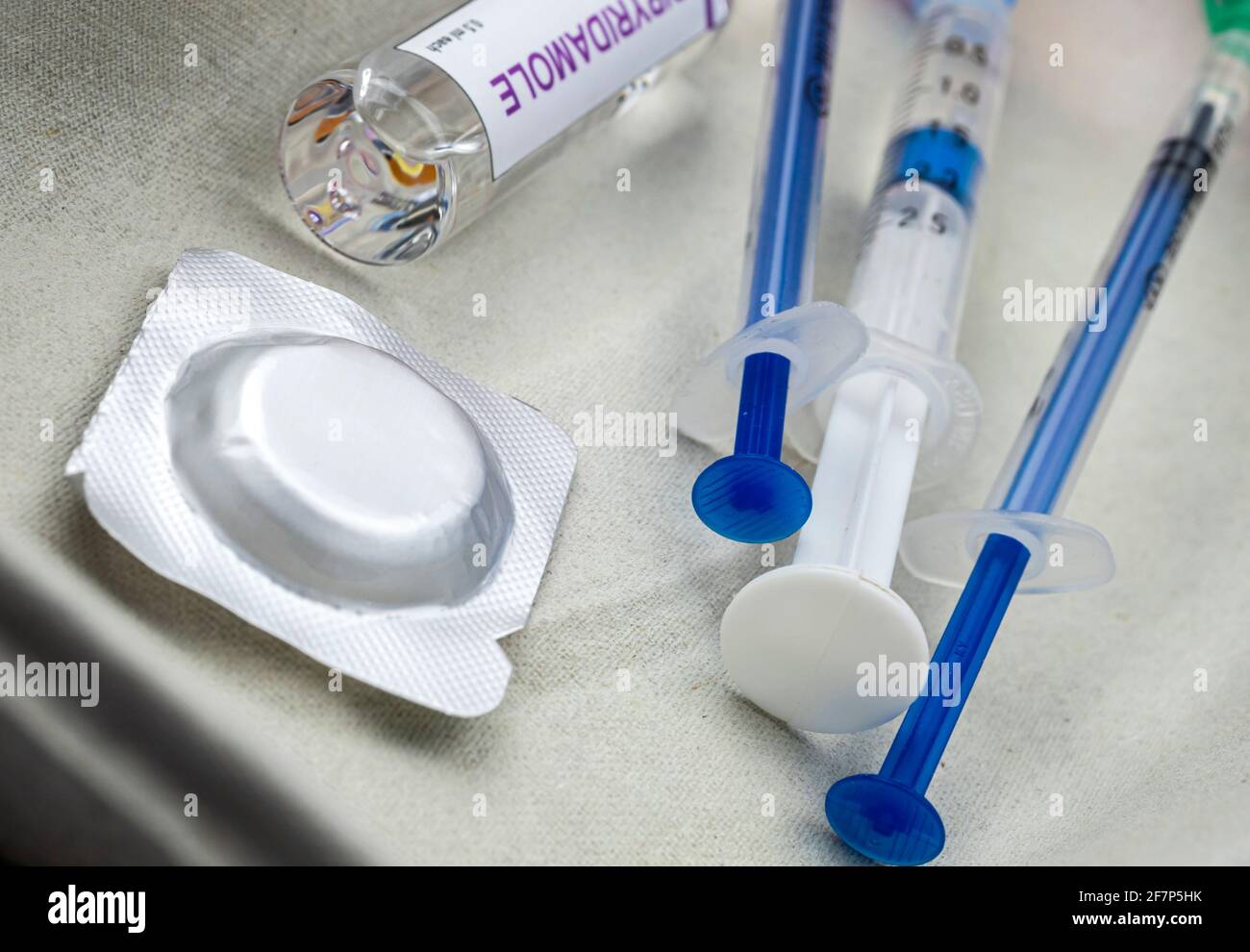 Syringes loaded with medication next to medicine vials prepared in hospital, conceptual image Stock Photo