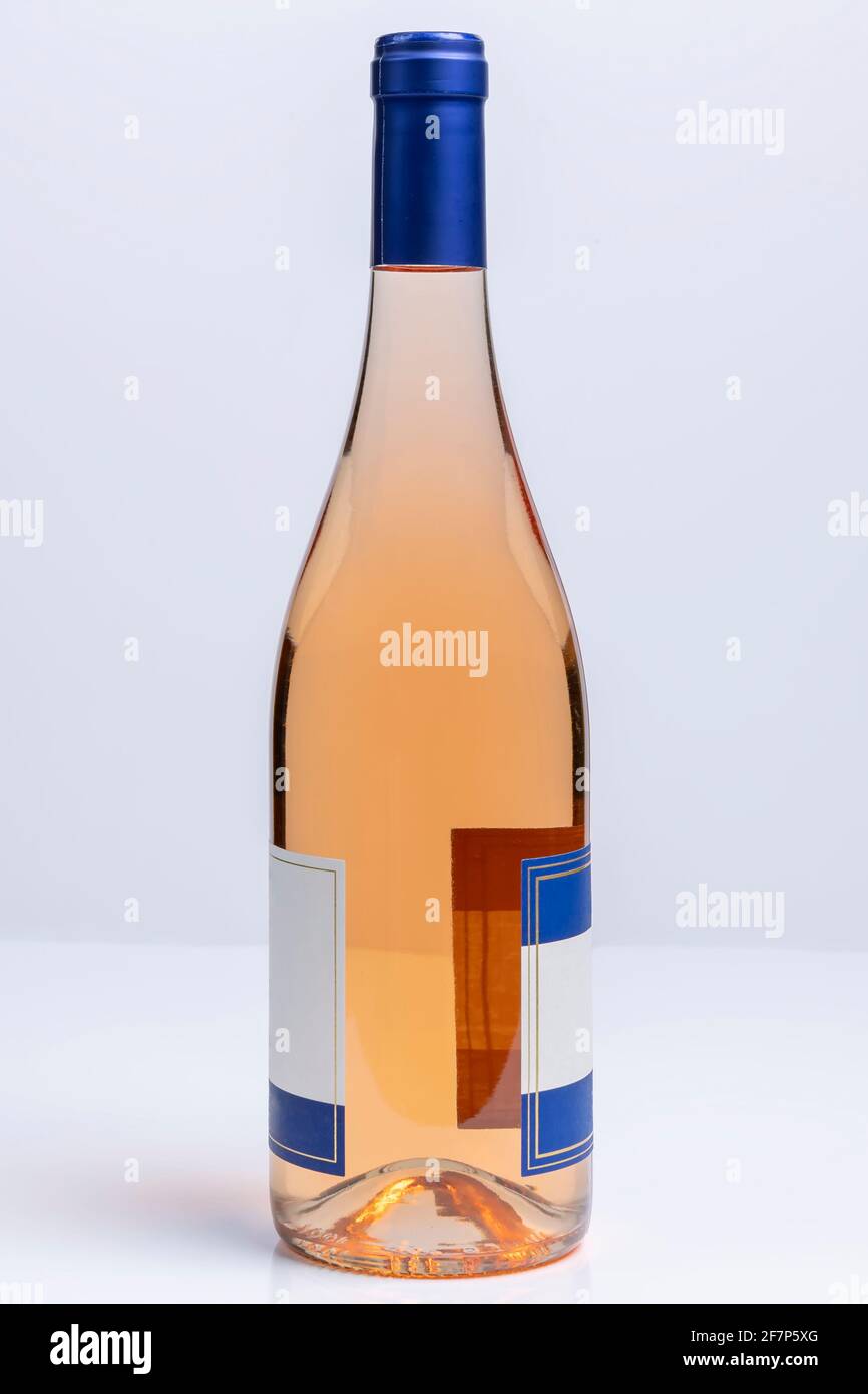 Beautiful burgundy style bottle of pinot grigio wine on white surface and background Stock Photo