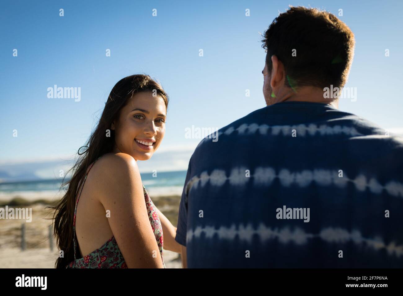 Portrait of caucasian couple on beach, woman looking to camera, smiling Stock Photo