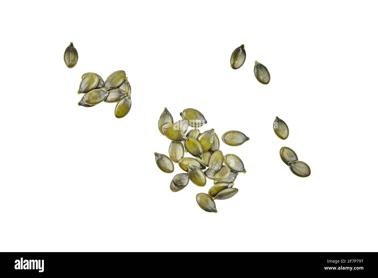 Seeds of gymnospermous pumpkin isolated on a white background. Scattered pumpkin seeds, top view Stock Photo