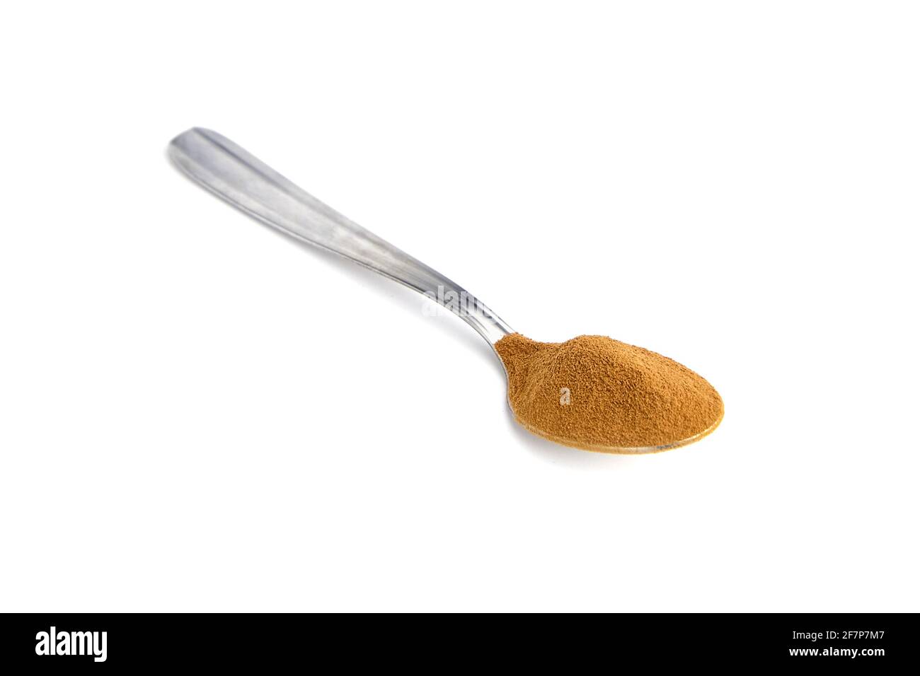 Chicory root powder in teaspoon isolated on white background. Chicory coffee, organic food additive Stock Photo