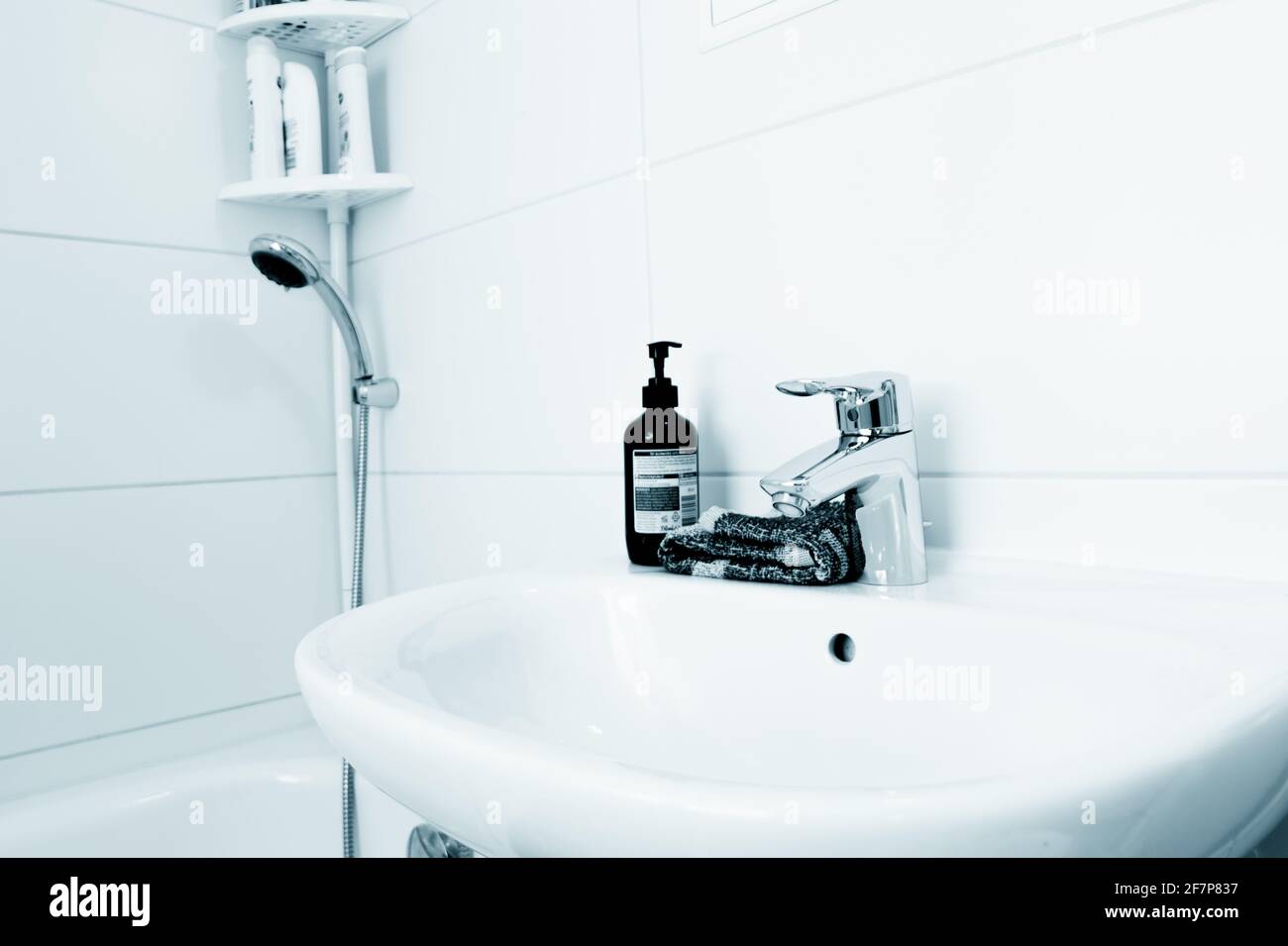Water tap and liquid soap in the bathroom Stock Photo