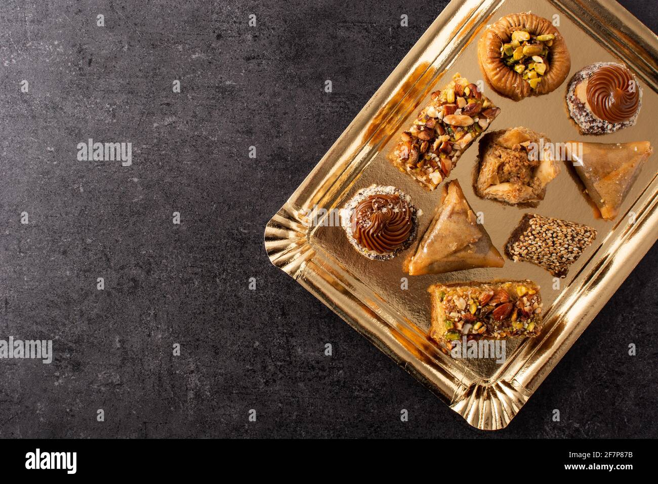 Assortment of Ramadan dessert baklava on black slate background Stock Photo