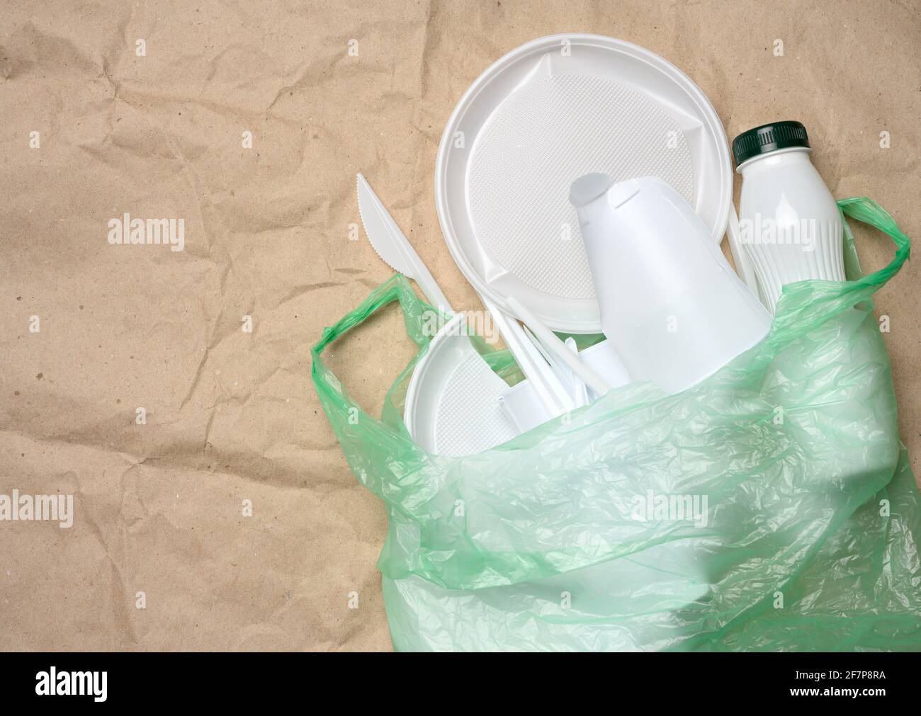 plastic waste from life on the background of brown kraft paper