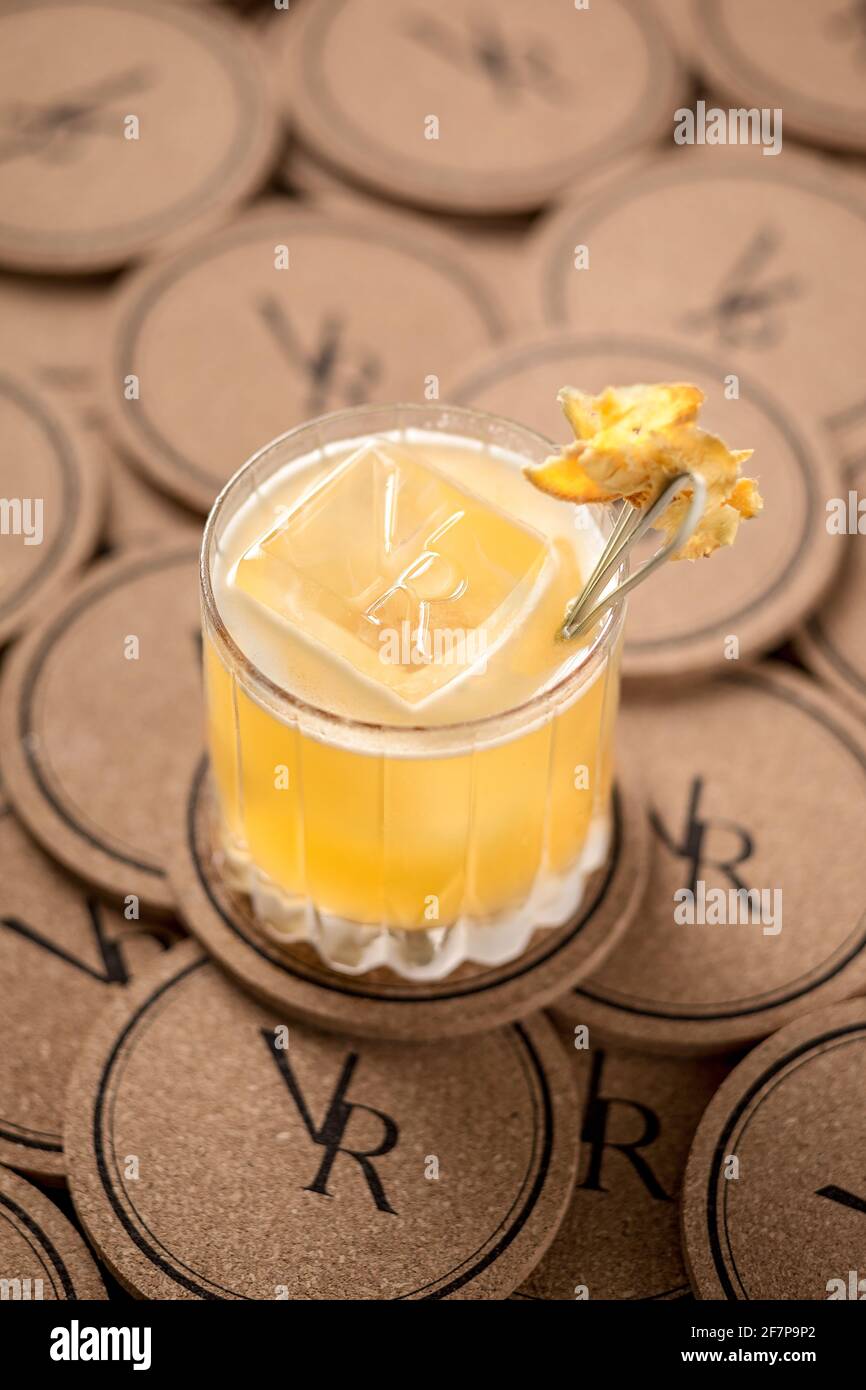 A vodka base fruity cocktail served with a large cube of ice. Stock Photo