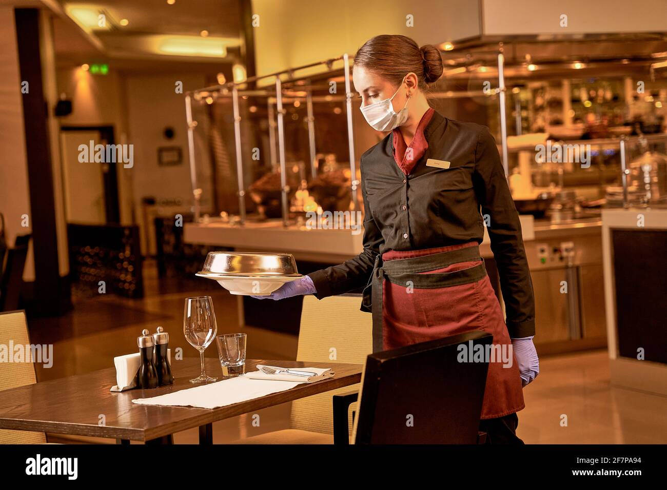 Helpful waitress serving the order to table Stock Photo