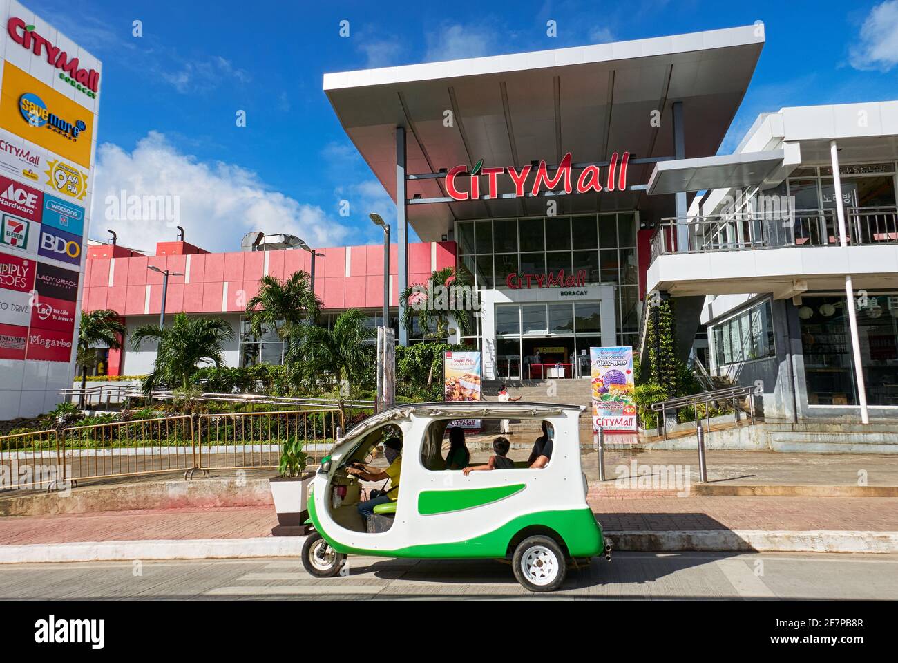 An electronic tricycle with passengers waiting in front of the newly build City Mall building on Boracay Island, Philippines, Asia Stock Photo