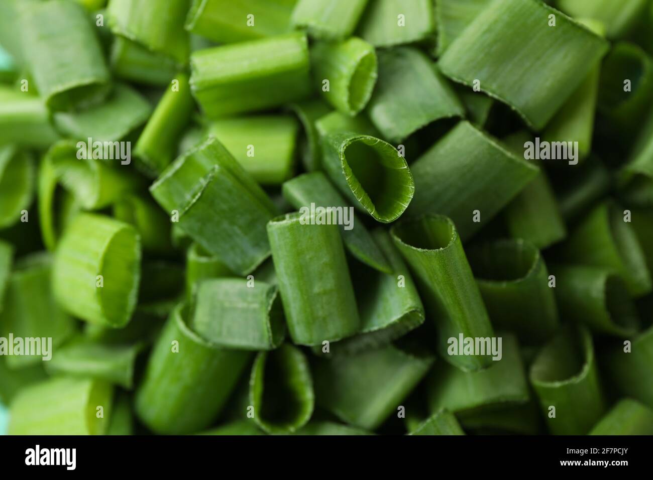 Chopped green onion on whole background, close up Stock Photo - Alamy