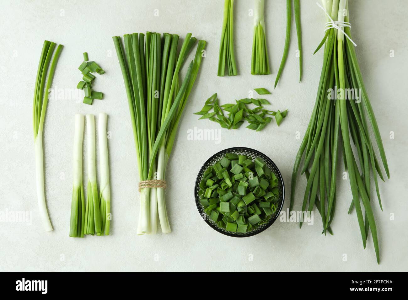 Fresh green onion on white textured background Stock Photo - Alamy
