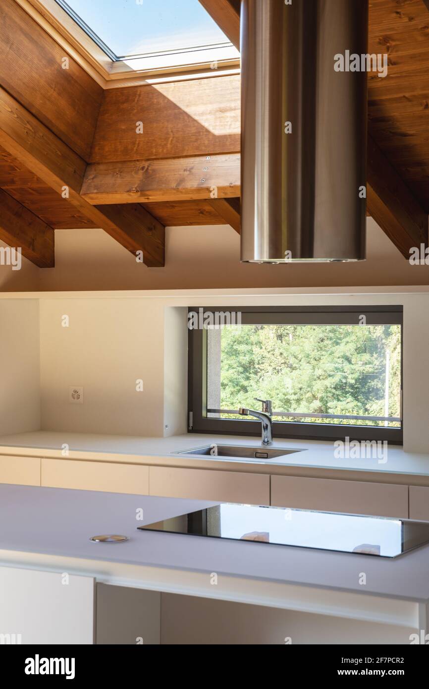 a kitchen with some uts hanging on the wall and an oven hood in the window  over the stovetop Stock Photo - Alamy