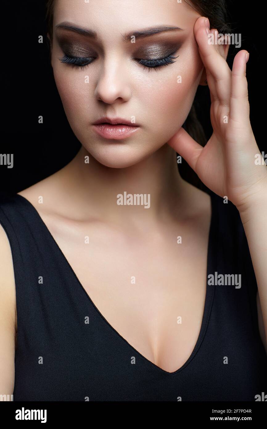 beauty-portrait-of-young-woman-with-hand-near-face-on-black-background