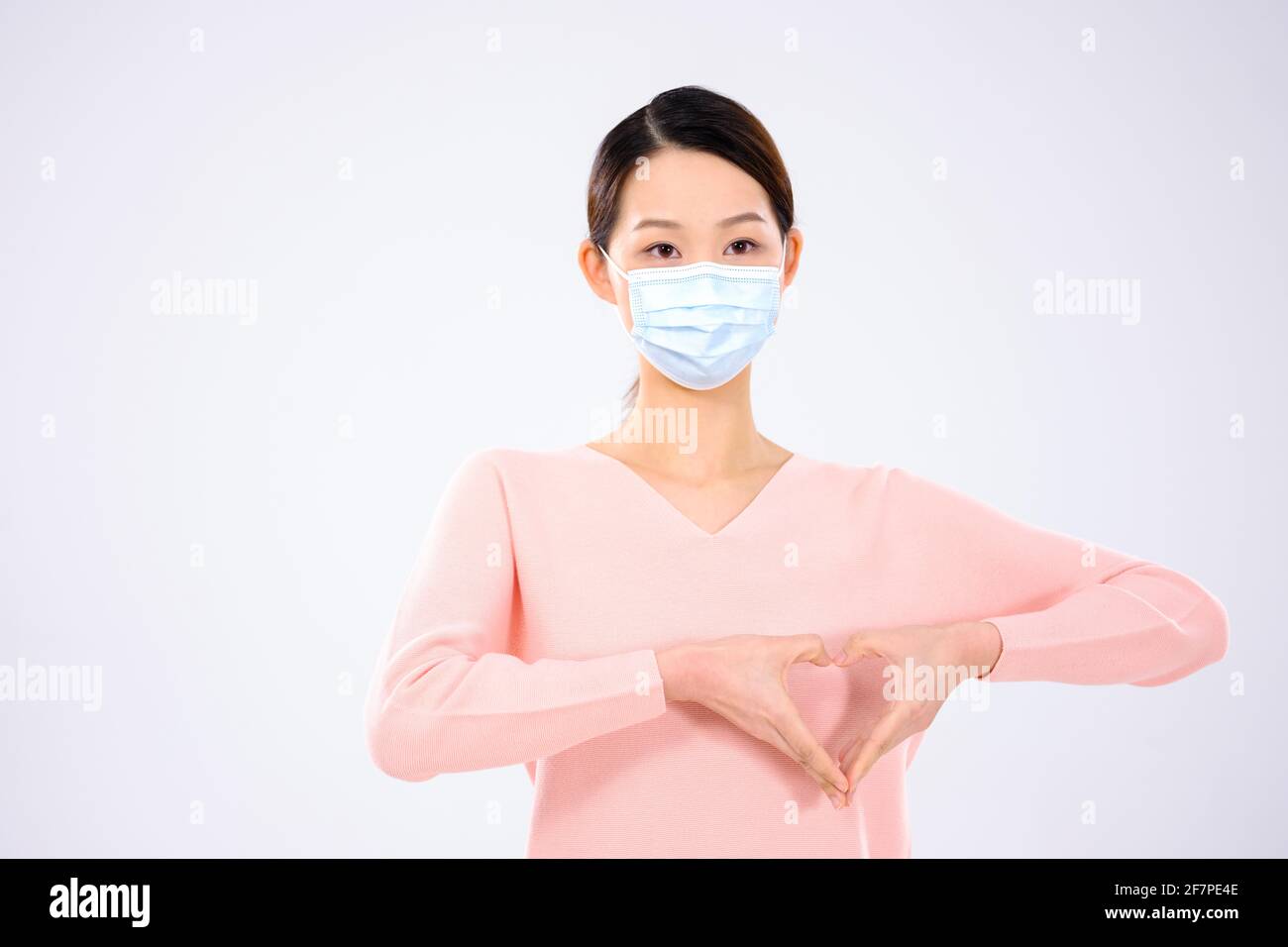 A young woman wearing a mask front view Stock Photo