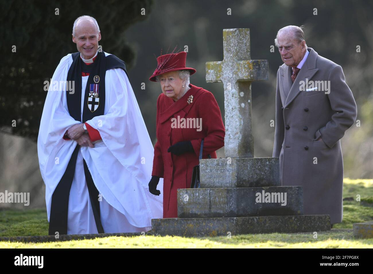 File photo dated 04/02/18 of Queen Elizabeth II and the Duke of Edinburgh with Canon Jonathan Riviere (left) as they attended St Peter and Paul Church in West Newton, Norfolk, for a Sunday morning service, whilst staying at Sandringham. The Queen privately owns Sandringham House and its vast surrounding estate, which includes 16,000 acres of farmland, 3,500 acres of woodland and 150 properties. Philip took on overall responsibility for the management of the estate at the start of the QueenÕs reign in 1952. He concentrated on maintaining it for future generations, ensuring conservation was at t Stock Photo
