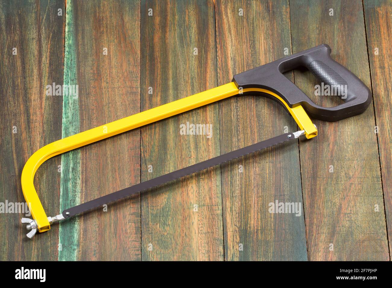 Saw bow, hand tools for sawing, isolated on wooden background Stock Photo