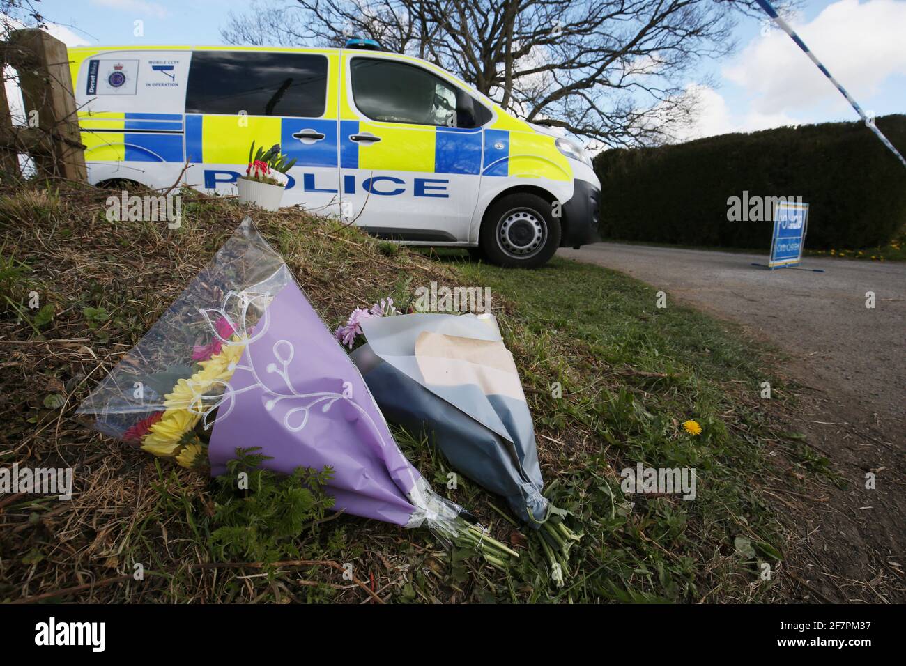 Flowers left by a cordon at the junction of Moor Lane and Langham Lane in Gillingham, Dorset, following the death of Sir Richard Sutton, who owned a string of top hotels in London, who died during an incident at a property near Gillingham, Dorset. A 34-year-old man arrested on suspicion of murdering the millionaire hotelier remains in hospital, police said. Picture date: Friday April 9, 2021. Stock Photo