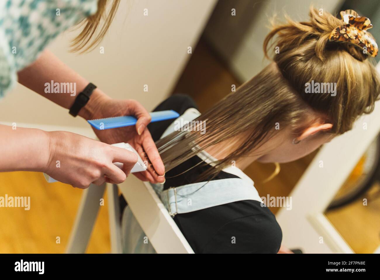 Young woman in home bathroom cutting her own hair with scissors Stock Photo  - Alamy