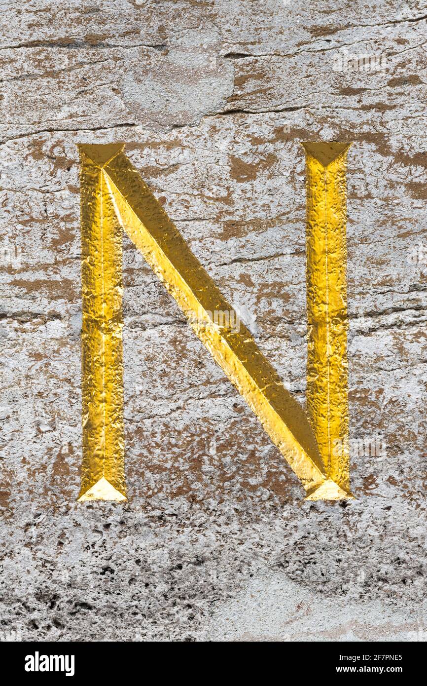 Golden letter N in natural stone Stock Photo