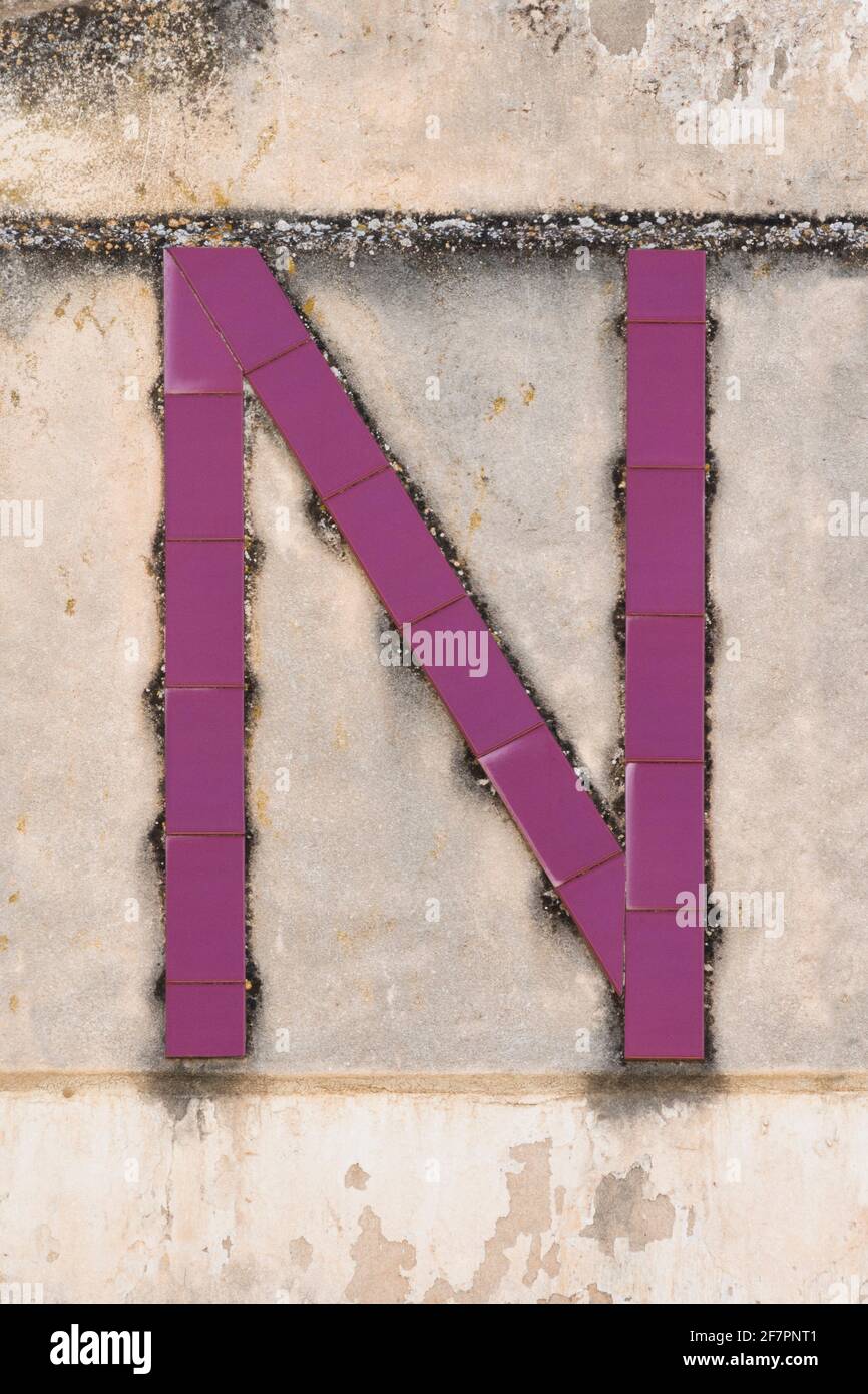 Letter N composed of wine red tiles Stock Photo