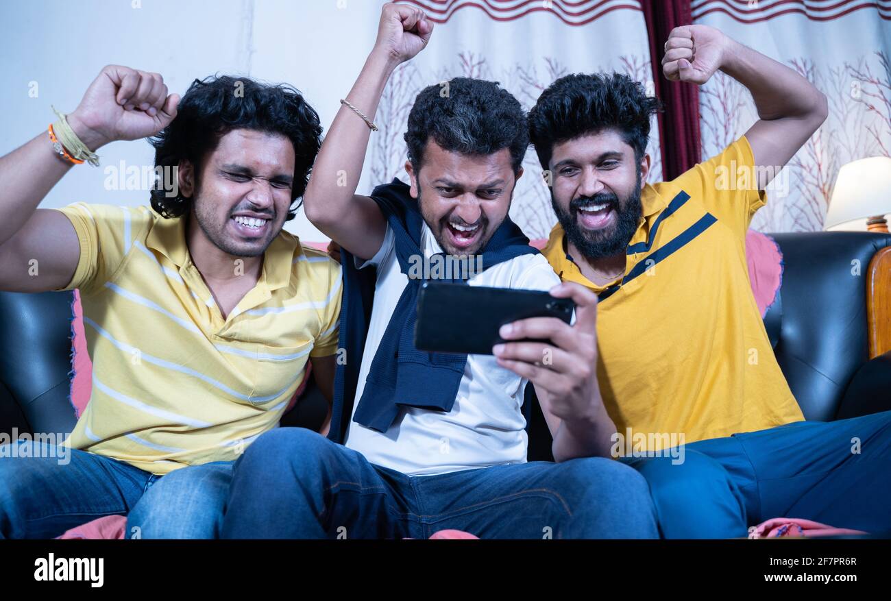 Three friends shouting and creaming while watching live streaming