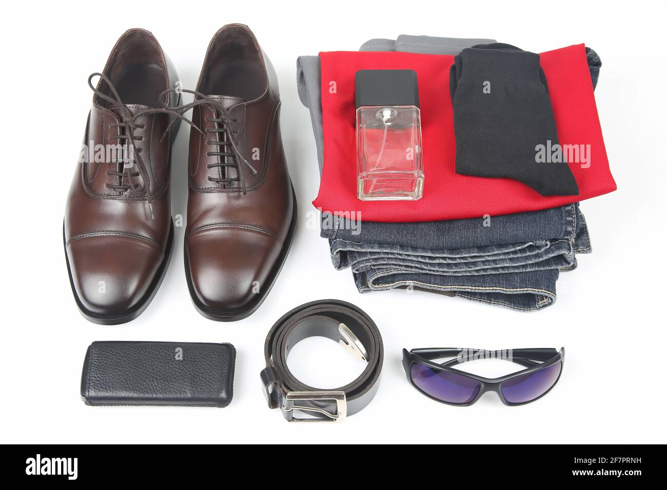 Classic men's shoes, belt, glasses, eau de toilette, clothes and mobile phone on white background Stock Photo