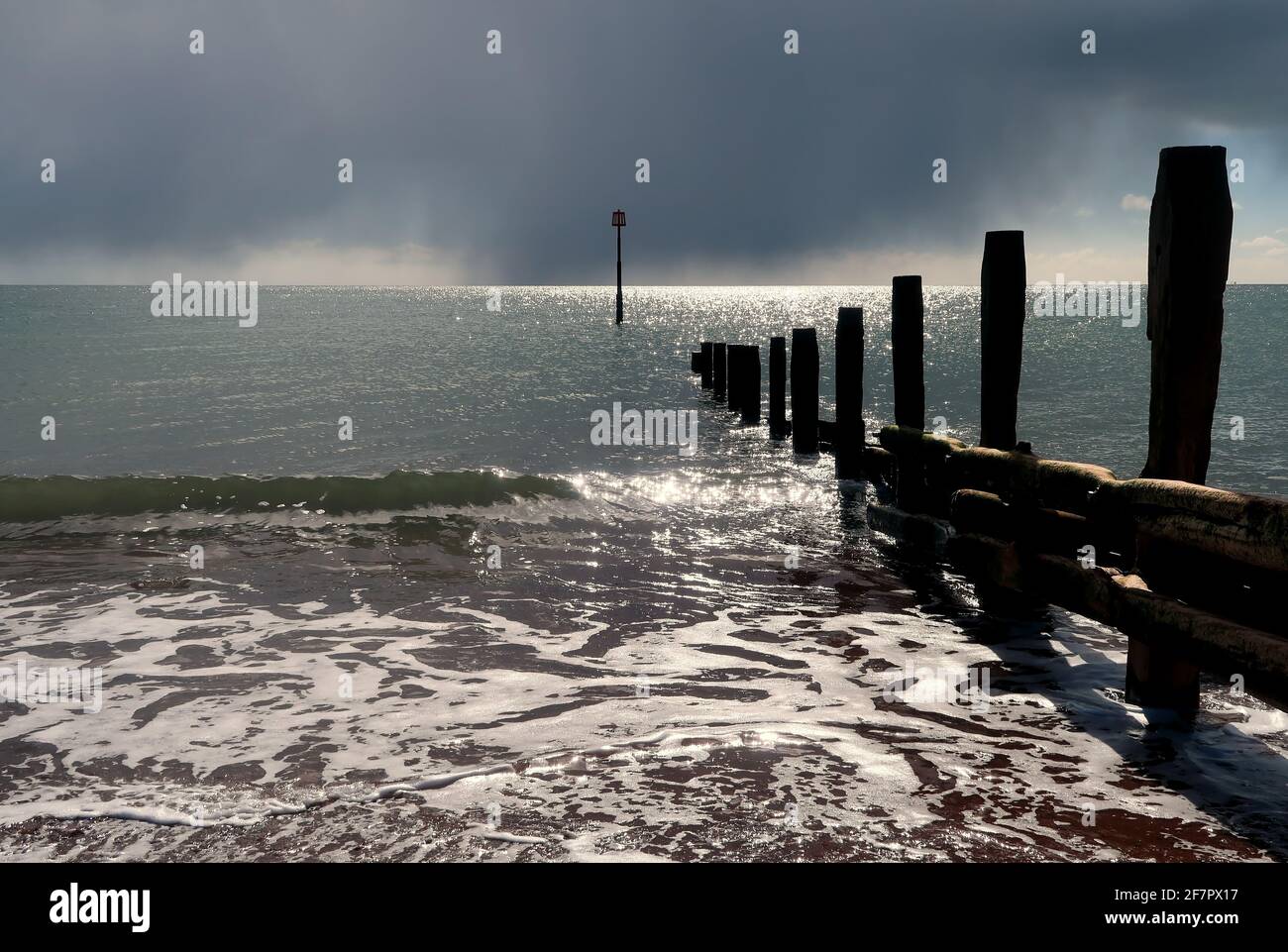 Sunlight and rain clouds over the sea Stock Photo - Alamy