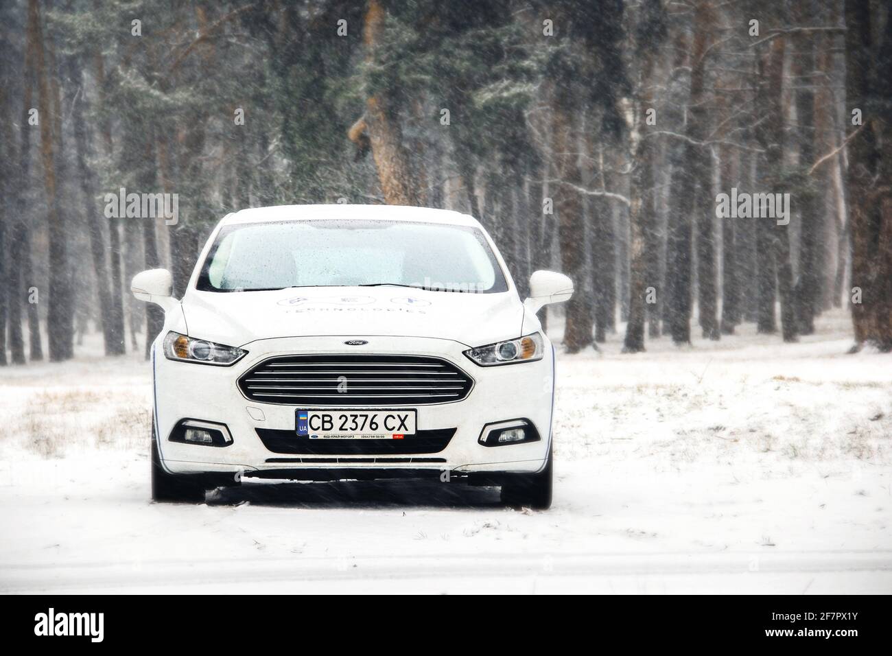 Chernigov, Ukraine - January 28, 2021: White Ford car in a snowy forest. Beautiful winter Stock Photo