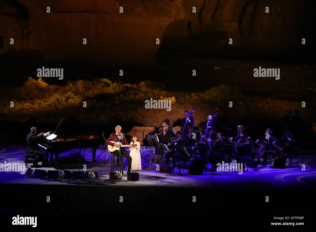 (210409) -- AL ULA, April 9, 2021 (Xinhua) -- Italian tenor Andrea Bocelli performs with his daughter Virginia at a concert in Al-Ula, northwestern Saudi Arabia, April 8, 2021. The Italian legendary tenor Andrea Bocelli on Thursday evening performed within the walls of Hegra, Saudi Arabia's first UNESCO World Heritage Site. TO GO WITH 'Italian tenor Bocelli performs in Saudi's world heritage site' (The Royal Commission for AlUla/Handout via Xinhua) Stock Photo