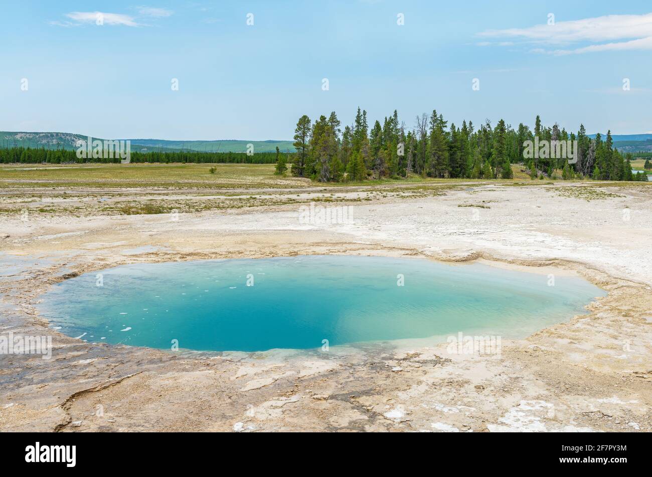 Blue hot spring hole by the Grand Prismatic Spring, Midway Norris geyser basin, Yellowstone national park, Wyoming, USA. Stock Photo