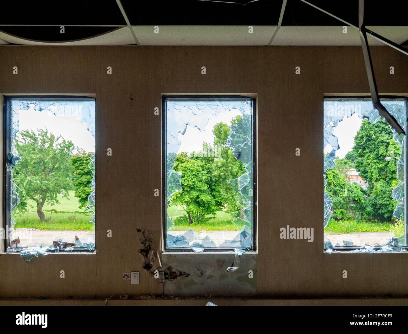 three broken windows with a view of trees outdoor Stock Photo Alamy