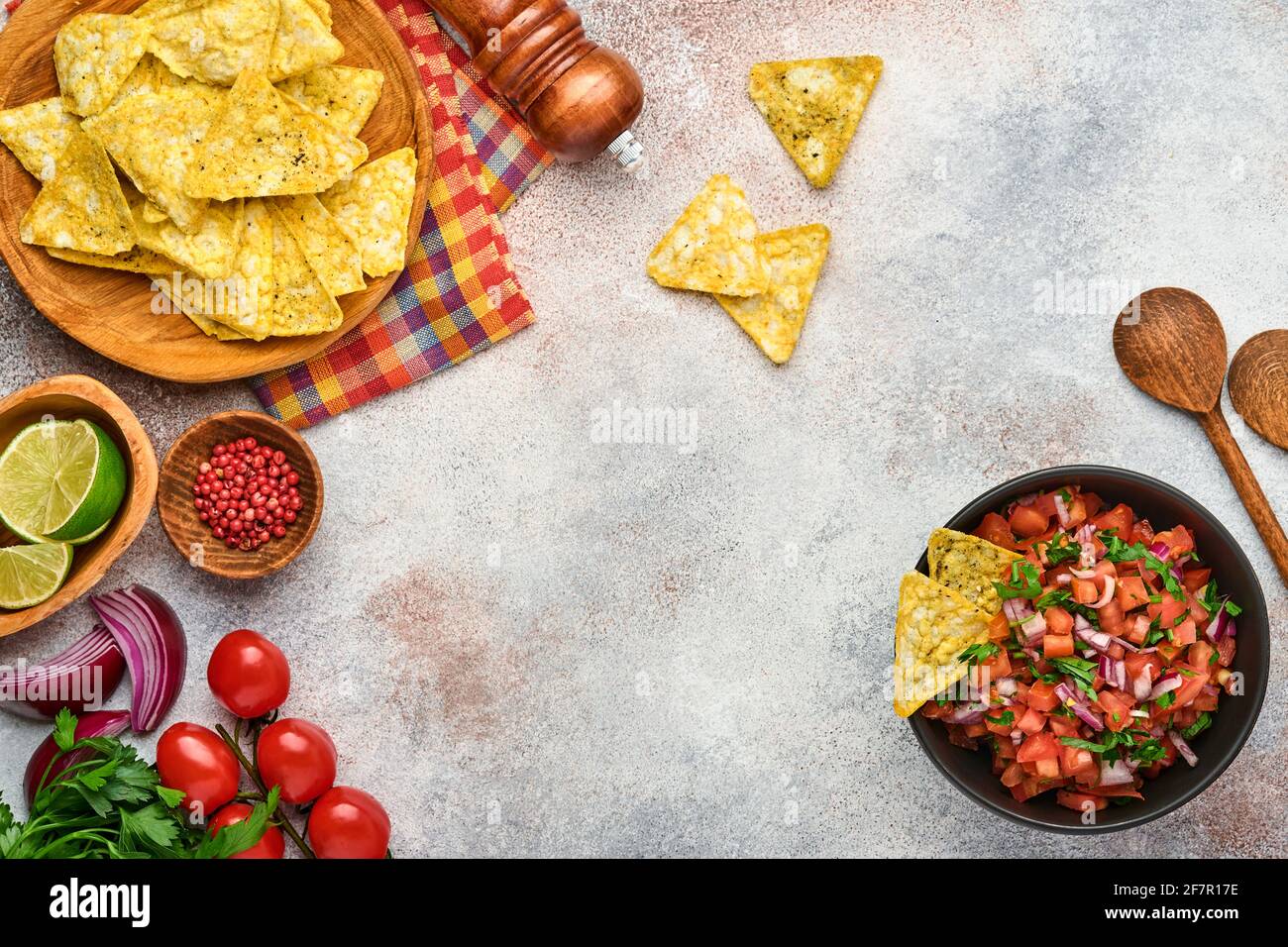 Traditional Mexican tomato sauce salsa with nachos and ingredients tomatoes, chile, garlic