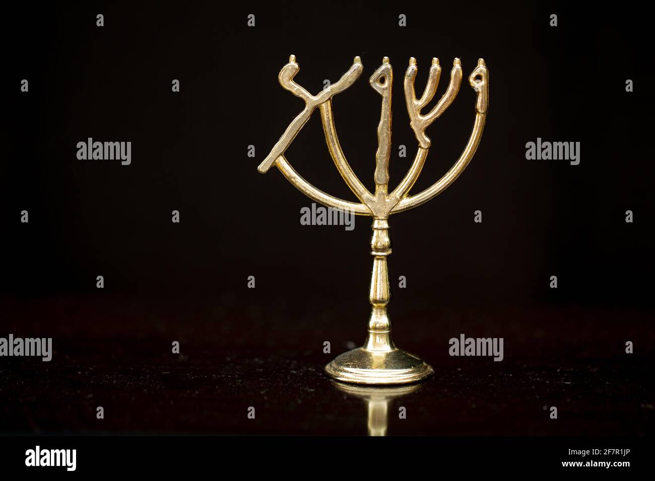 Jewish Menorah and Ark of Covenant 31Make a lampstand of pure gold. Hammer out its base and shaft, and make its flowerlike cups, buds and blossom. Stock Photo