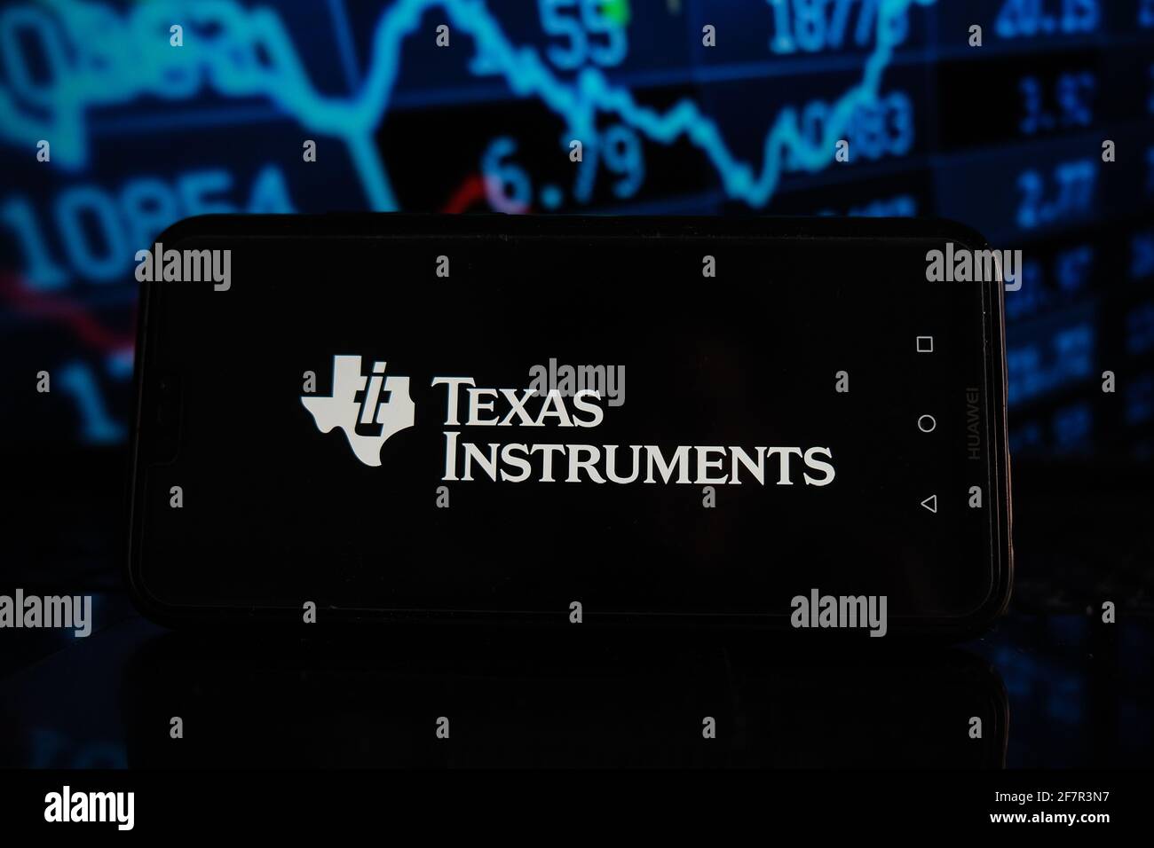In this photo illustration a Texas Instruments logo seen displayed on a  smartphone with stock market percentages in the background Stock Photo -  Alamy