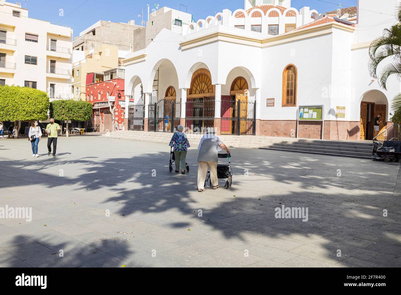 People in the church square of Nuestra Señora del Carmen in Los Cristianos, Tenerife, Canary Islands, Spain Stock Photo