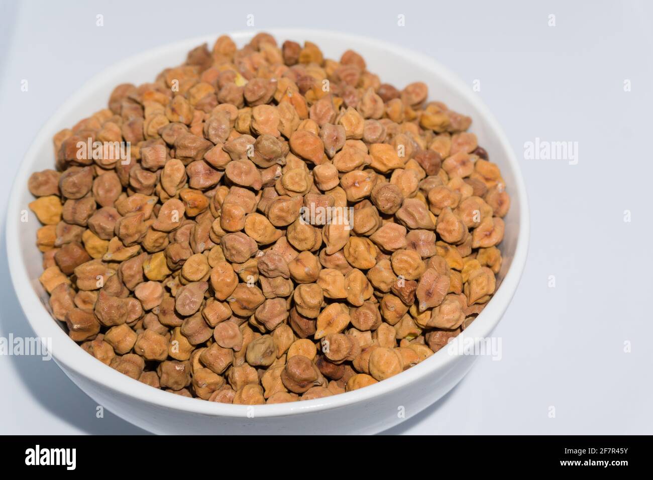 A bowl of black chickpeas in studio settings. Kabuli chana is believed to be one of the earliest cultivated legumes. It is a small, hard, knobby, beig Stock Photo