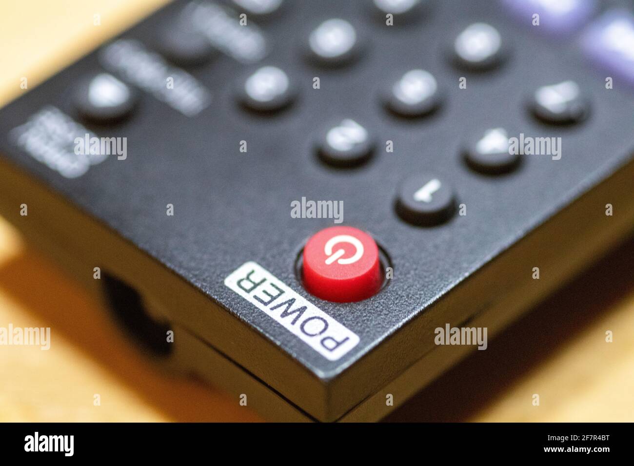 Red power button close-up on TV remote control Stock Photo