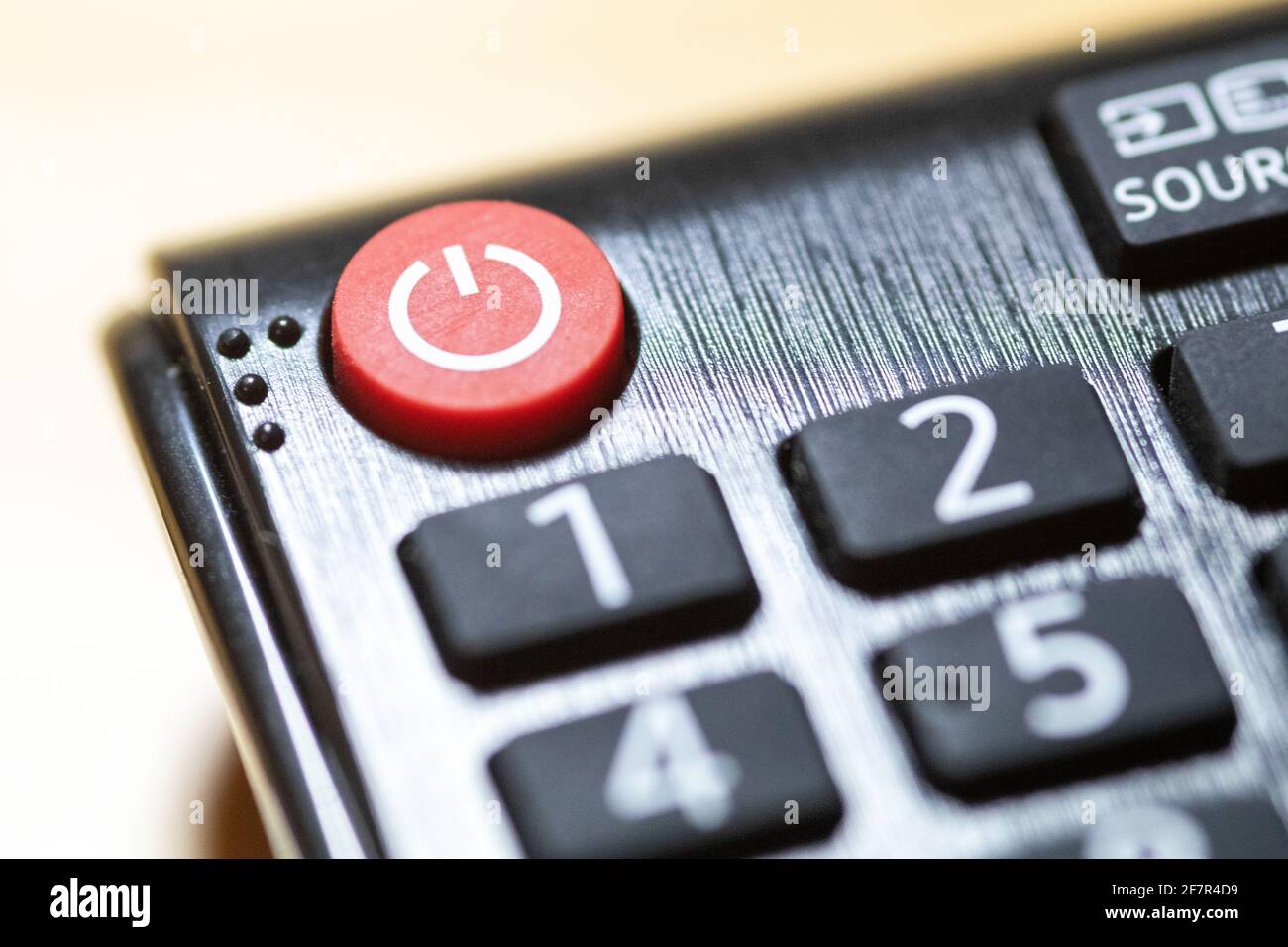 Button close-up on TV remote control with braille Stock Photo