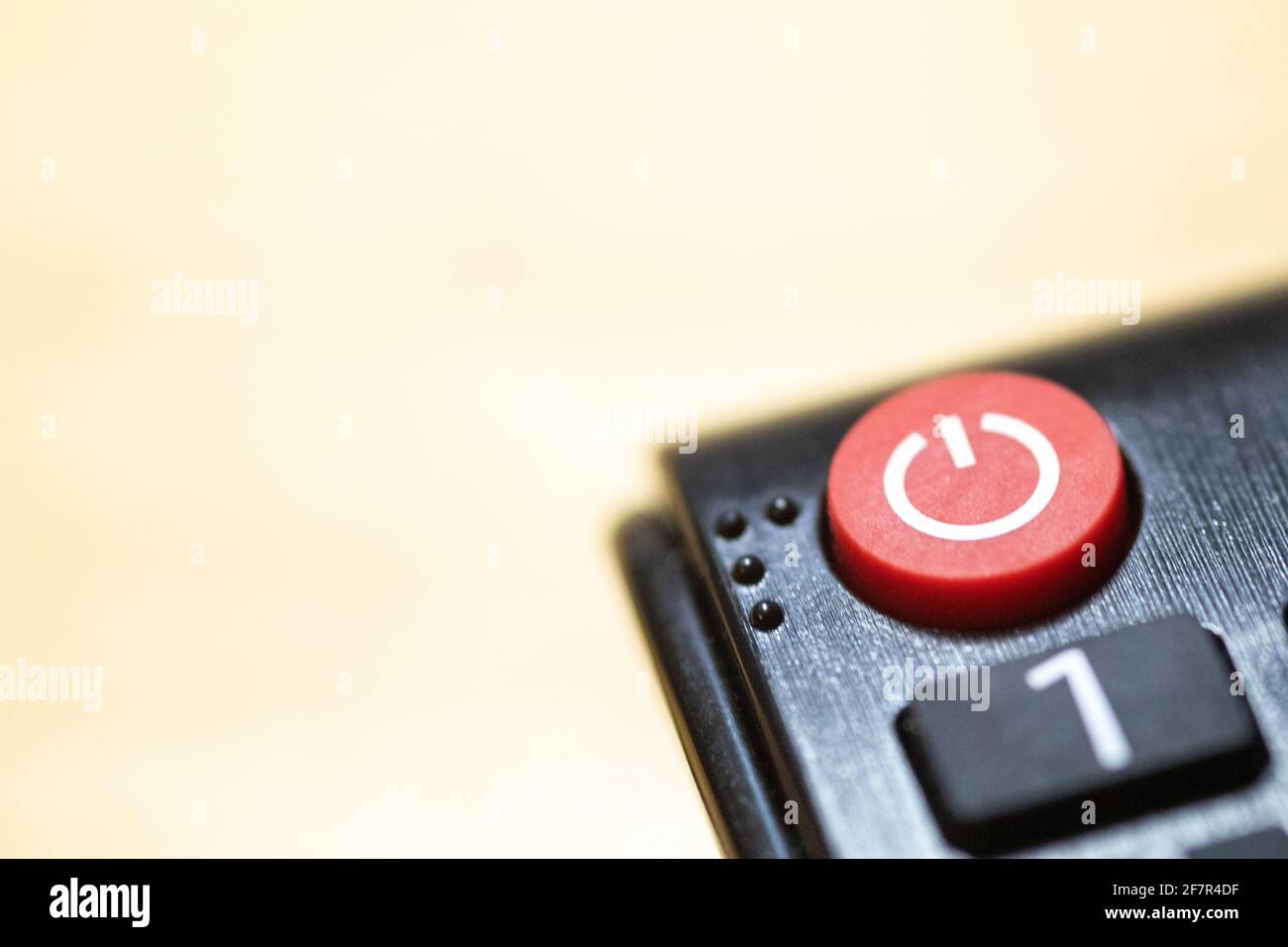 Power button close-up on TV remote control with braille and copy space ...