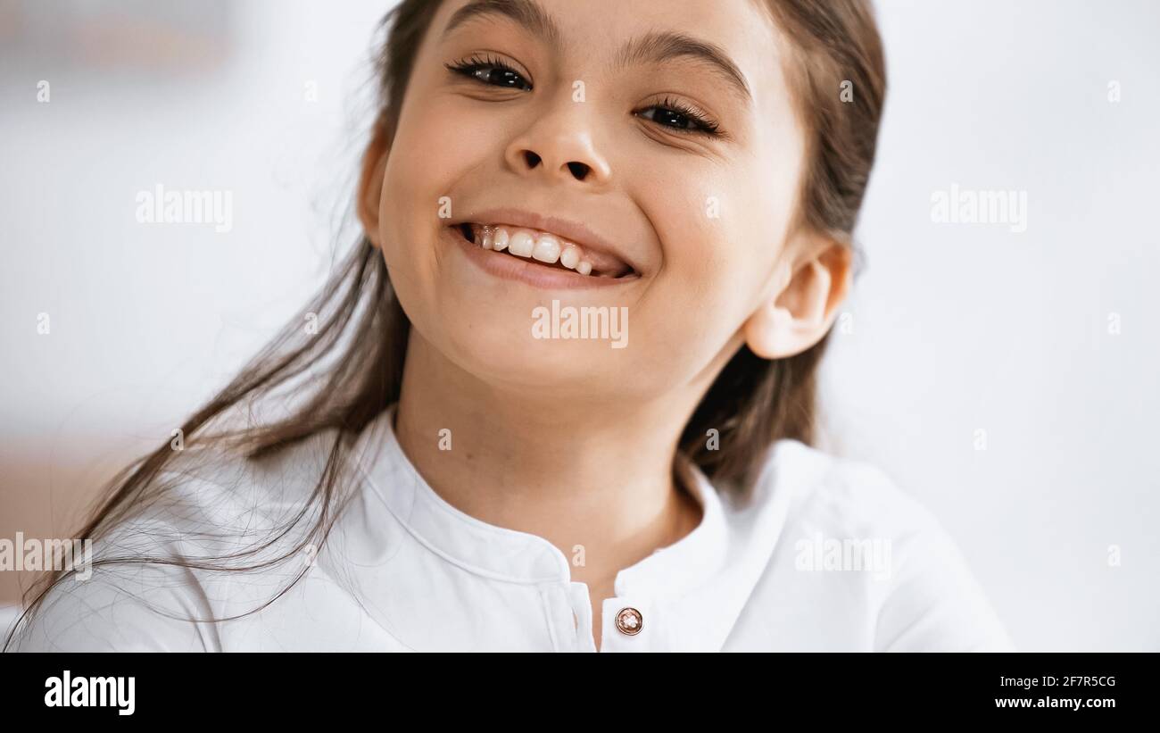 Cheerful preteen girl looking at camera Stock Photo - Alamy
