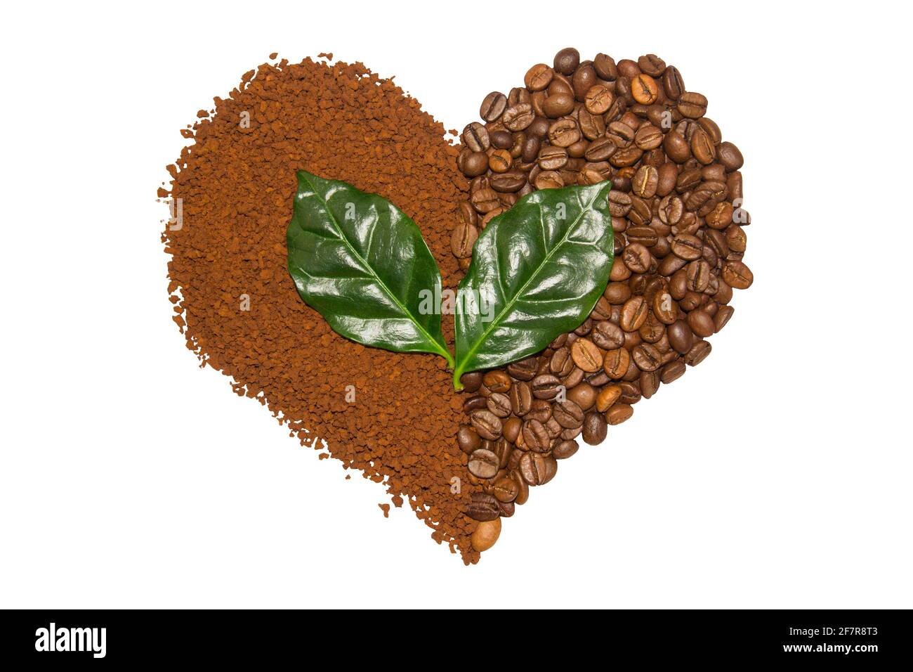 Double coffee heart made from beans and instant coffee and green leaves. Fresh roast. Love Stock Photo