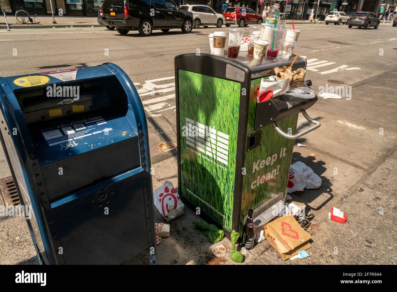 A fine selection of garbage from an overflowing street trash receptacle
