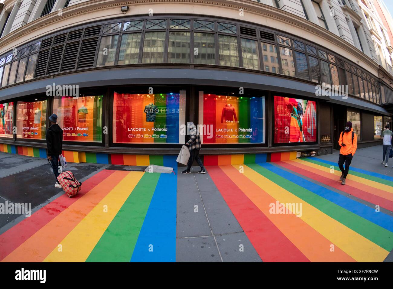 A worker removes a vinyl rainbow from in front of MacyÕs department store on Tuesday, March 30, 2021. The display was part of a promotion for the Lacoste X Polaroid collaboration that was sold at MacyÕs. The rainbow has been part of the Polaroid logo since PolaroidÕs first color instant film was introduces in 1963. (© Richard B. Levine) Stock Photo