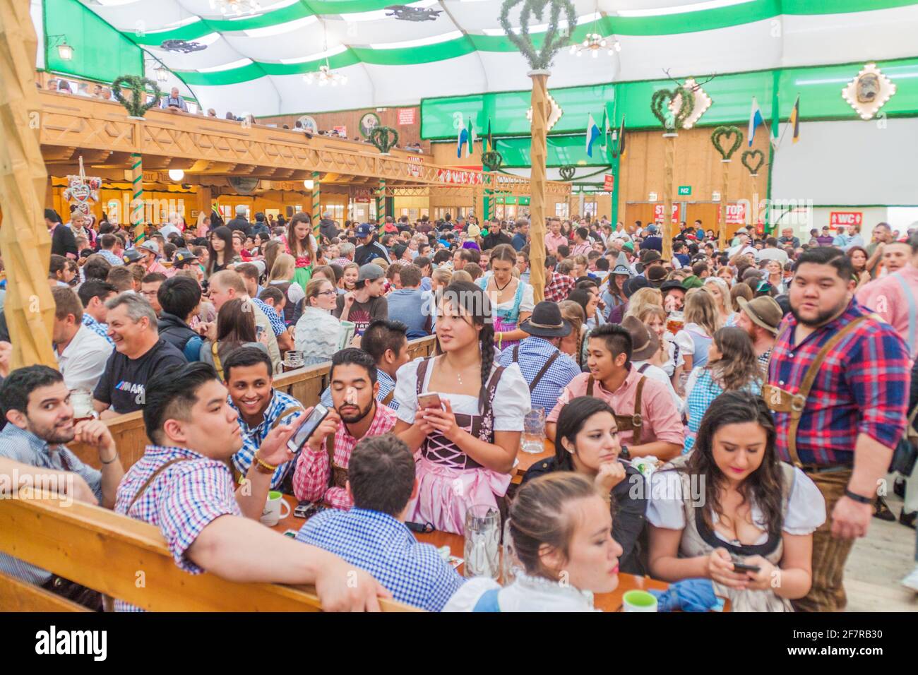 MUNICH, GERMANY - SEPTEMBER 17, 2016: People drink beer in one of the tents of the Oktoberfest in Munich. Stock Photo