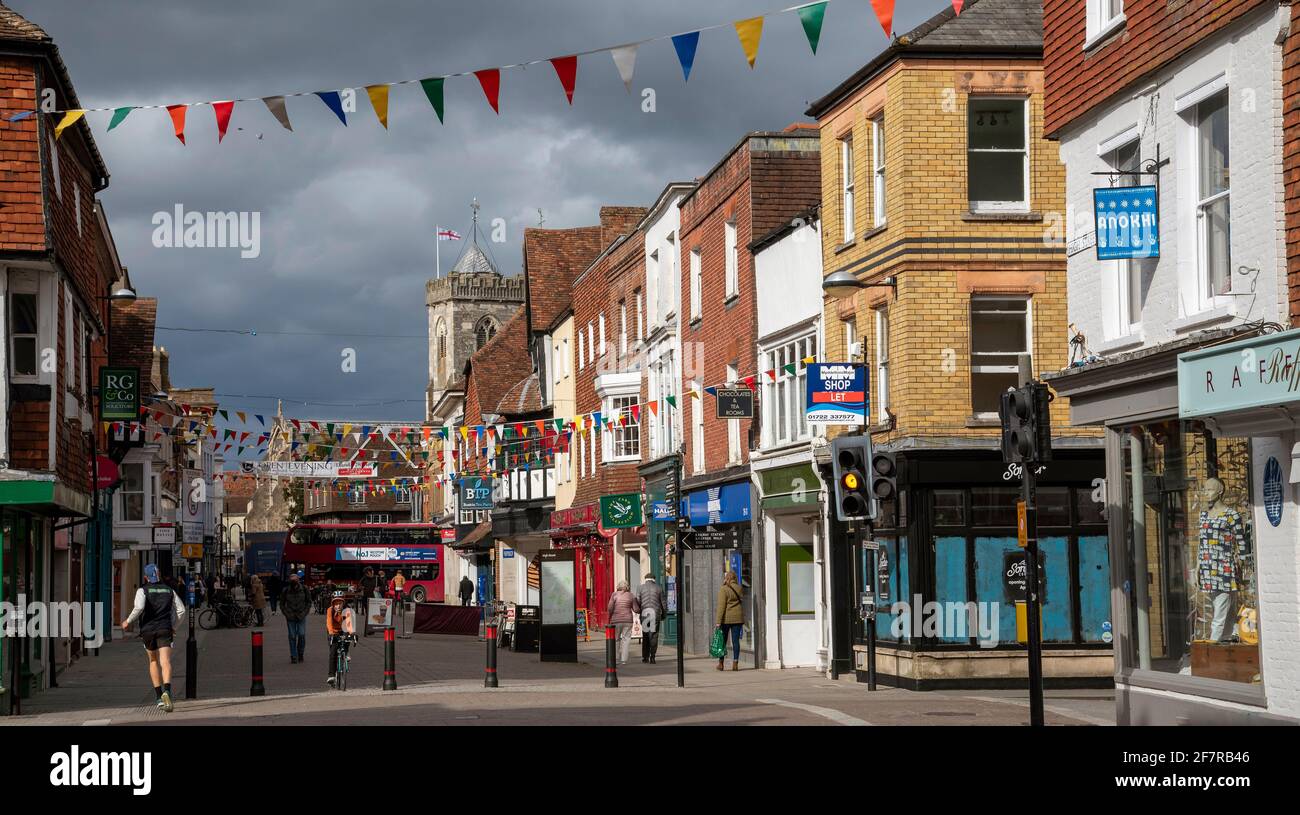 Salisbury, Wiltshire, England, UK. 2021.  Shopping area of Salisbury city centre during Civid lockdown in sunlight with a darkened stormy sky. Stock Photo