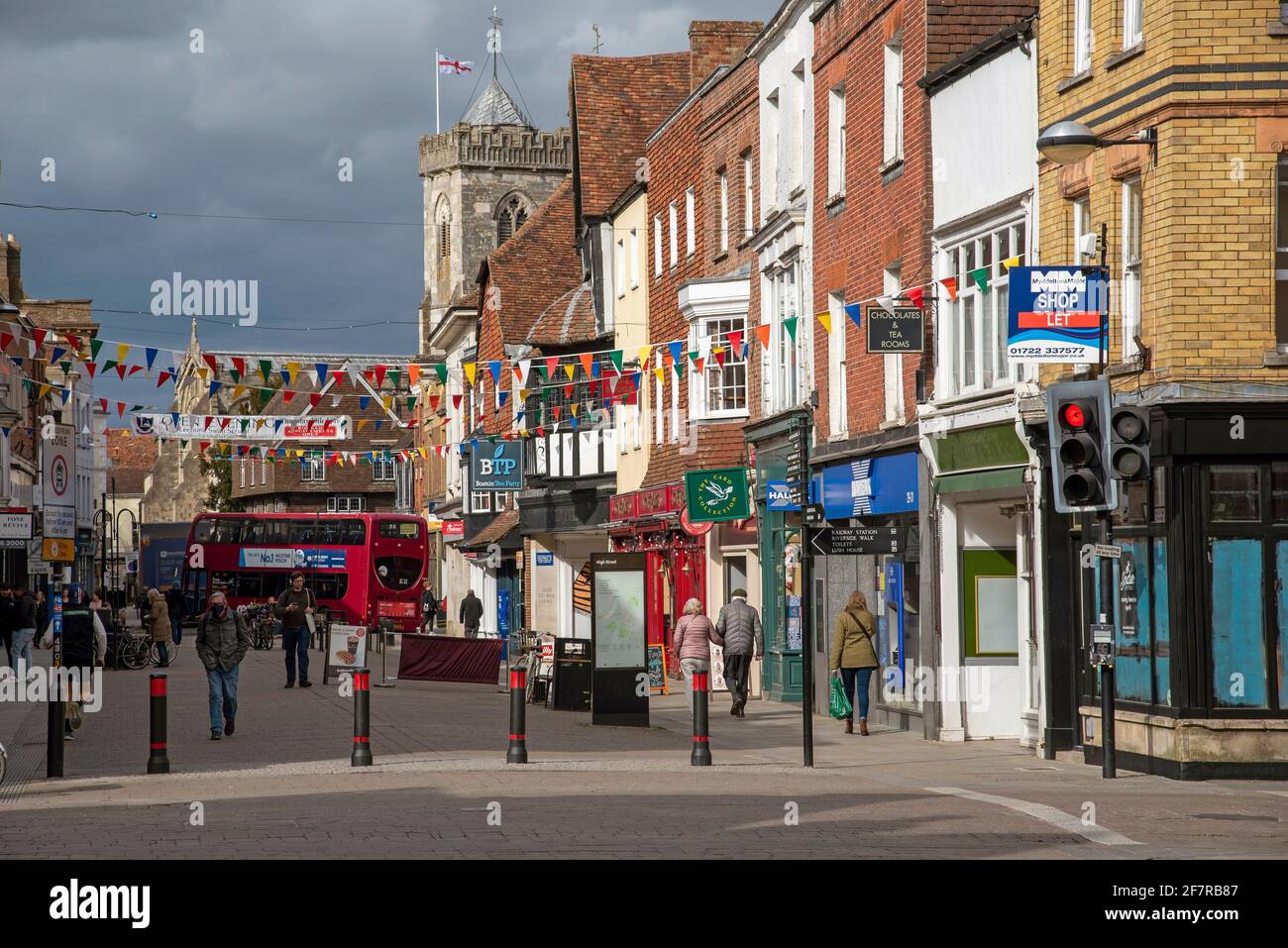 Salisbury, Wiltshire, England, UK. 2021.  Shopping area of Salisbury city centre during Civid lockdown in sunlight with a darkened stormy sky. Stock Photo
