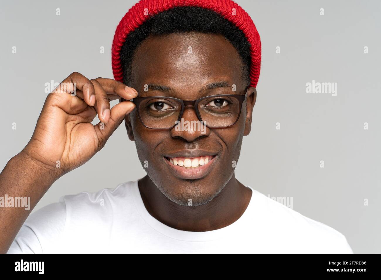 Closeup portrait of young african hipster guy with broad toothy smile isolated on white background Stock Photo