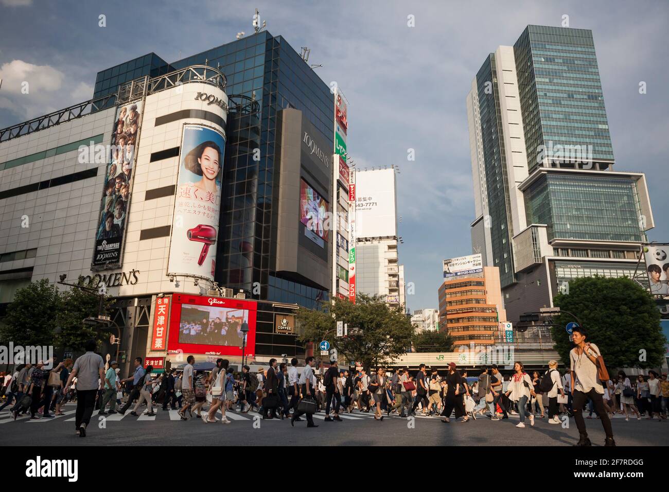 Panoramic view of the pedestrian hustle and bustle in Shibuya Crossing at sunset, Shibuya, Tokyo, Japan Stock Photo